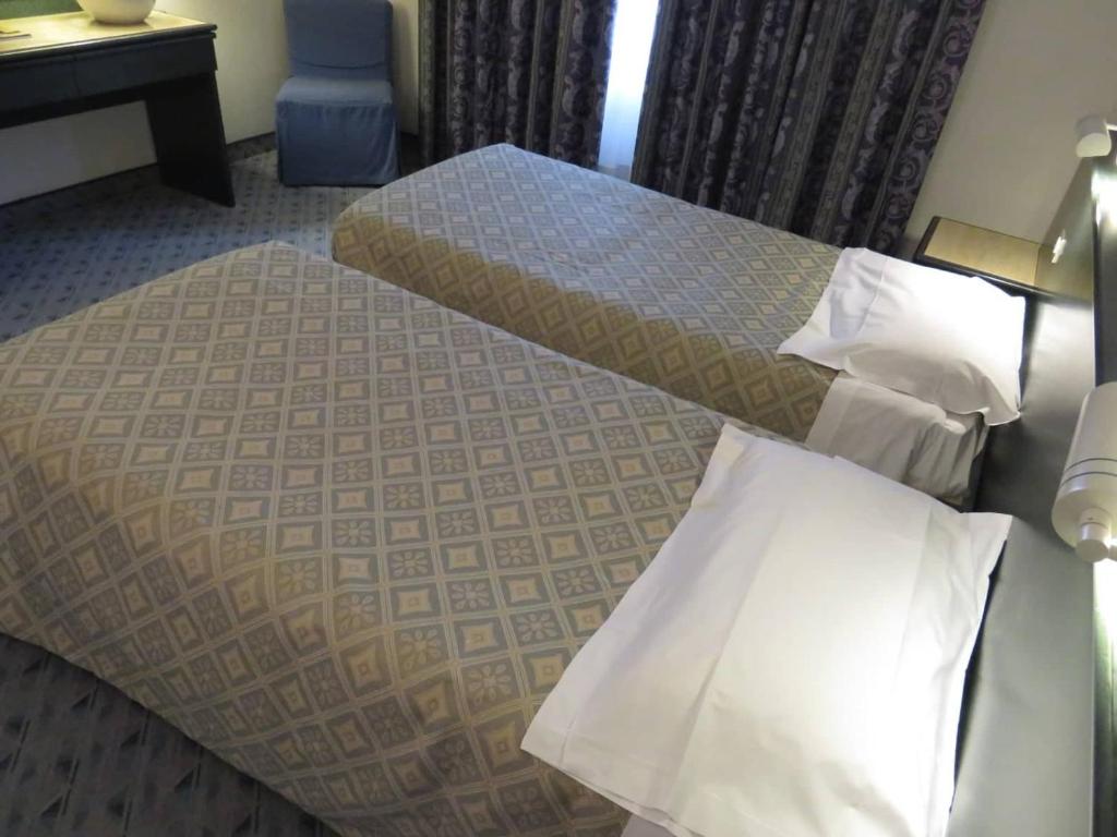 Postel nebo postele na pokoji v ubytování Hotel Turandot