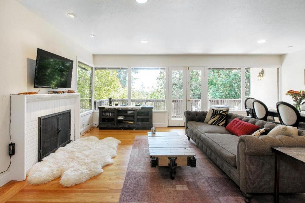 a living room with a couch and a fireplace at Landmark North Berkeley home in Berkeley