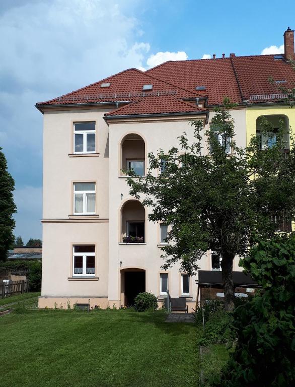 a large white house with a tree in front of it at Südvorstadt in Zittau