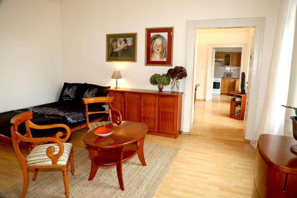 a living room with a couch and a table and chairs at Apartamenty Magiczny Kraków in Kraków