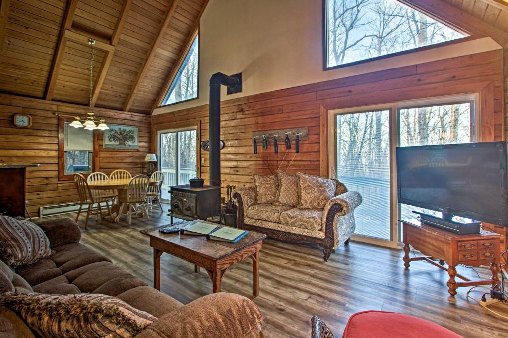 a living room with a large flat screen tv at Wintergreen Home with Deck - Near Skiing and Hiking! in Wintergreen