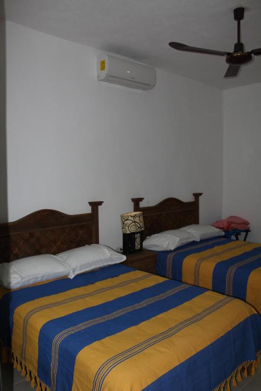 Postel nebo postele na pokoji v ubytování Hotel Casona Margot