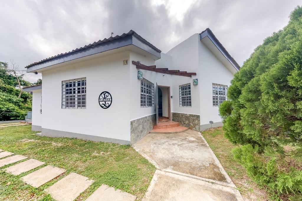 a white house with a driveway at La Rana in San Ignacio