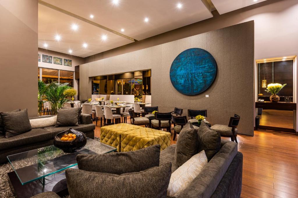 a living room with couches and a table and chairs at Hotel Cabrera Imperial By key 33 in Bogotá