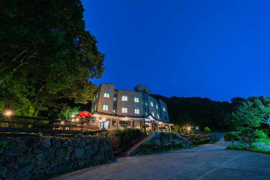 a building at night with a blue sky at Hooni Guest House & Motel in Gurye