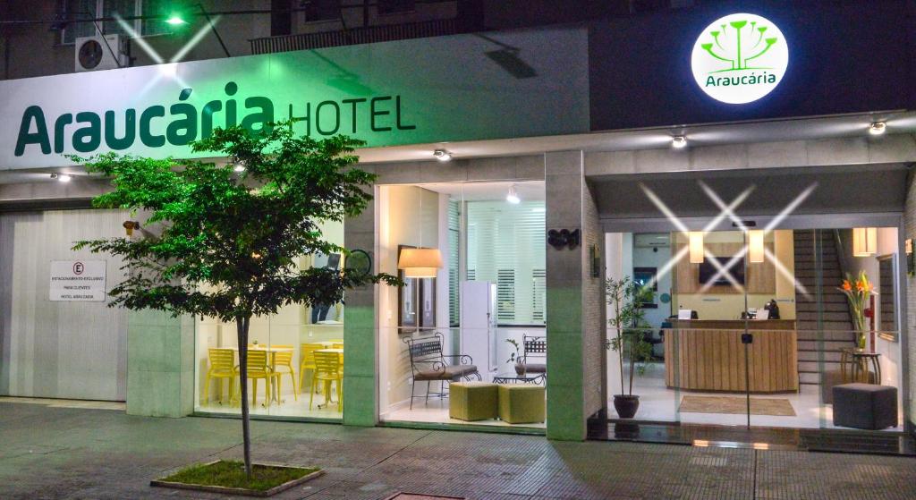 a store front of a furniture store at night at Araucaria Hotel Business - Maringá in Maringá