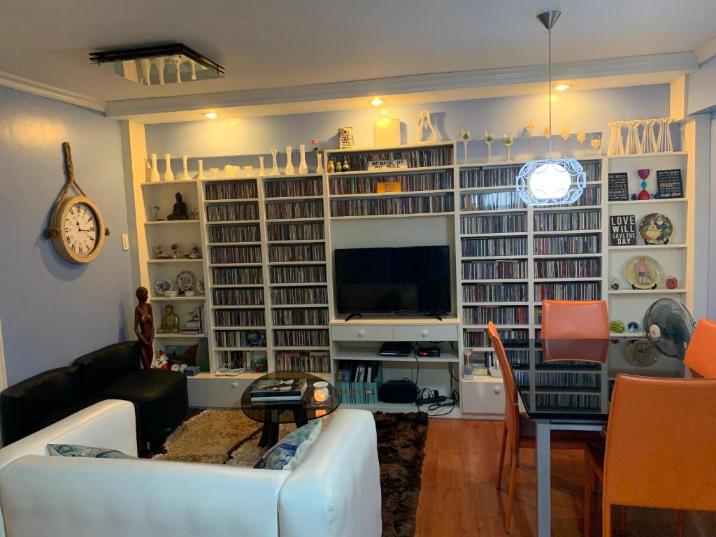 a living room with a couch and a tv at Northpoint Camella Condo Suites in Davao City