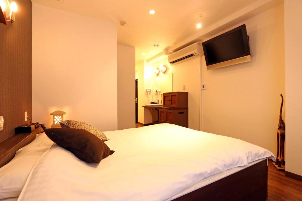Postel nebo postele na pokoji v ubytování Hotel 3 O'Clock Tennoji