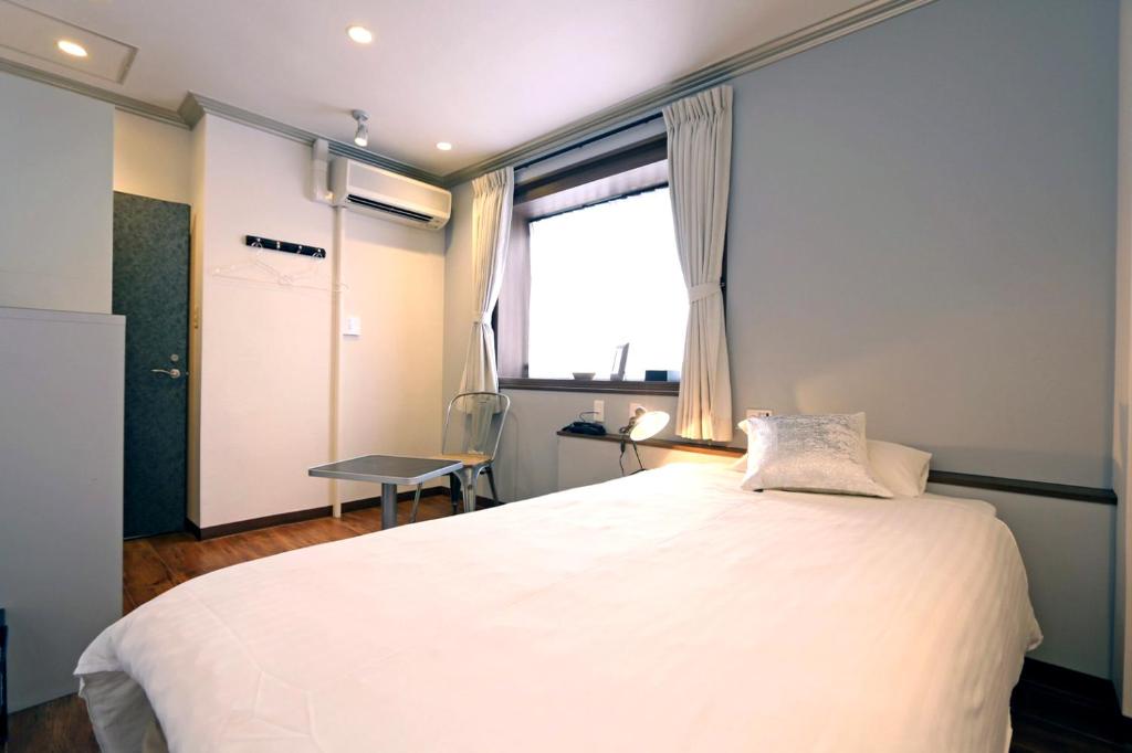 Postel nebo postele na pokoji v ubytování Hotel 3 O'Clock Tennoji
