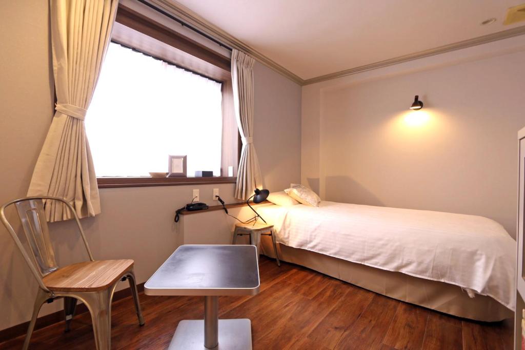 Postel nebo postele na pokoji v ubytování Hotel 3 O'Clock Tennoji