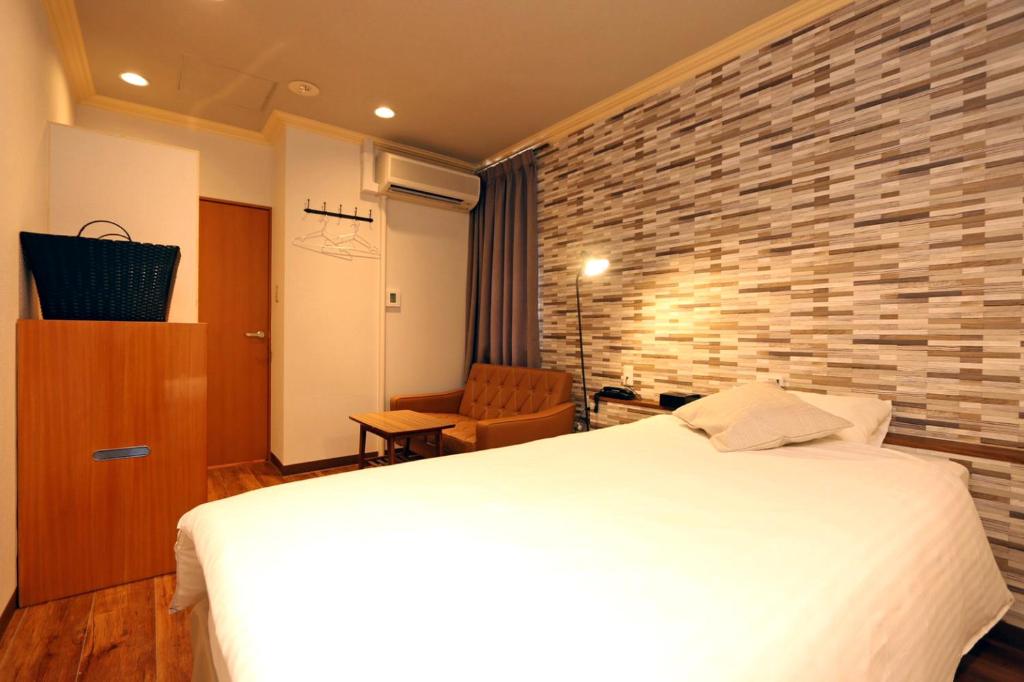 Postel nebo postele na pokoji v ubytování Hotel 3 O'Clock Tennoji