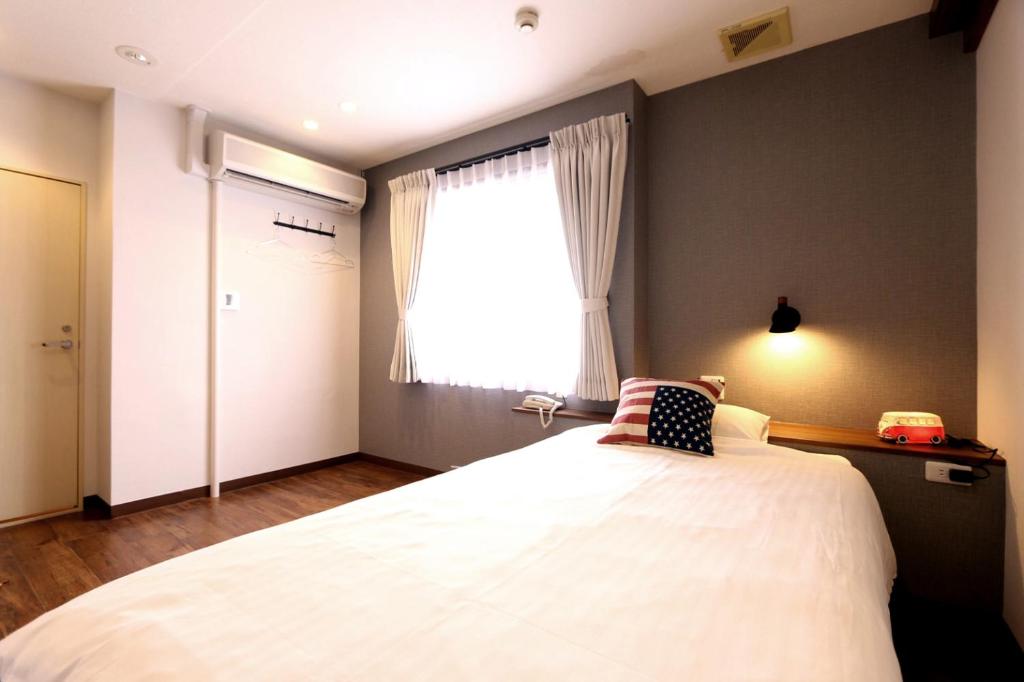 Postel nebo postele na pokoji v ubytování Hotel 3 O'Clock Tennoji