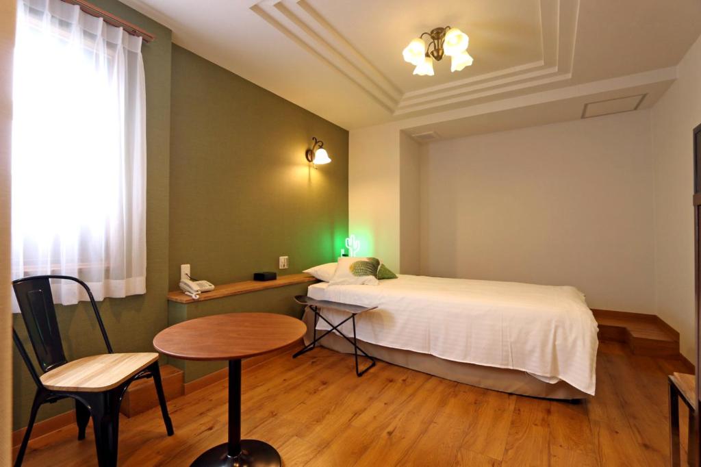 Postel nebo postele na pokoji v ubytování Hotel 3 O'Clock Tennoji