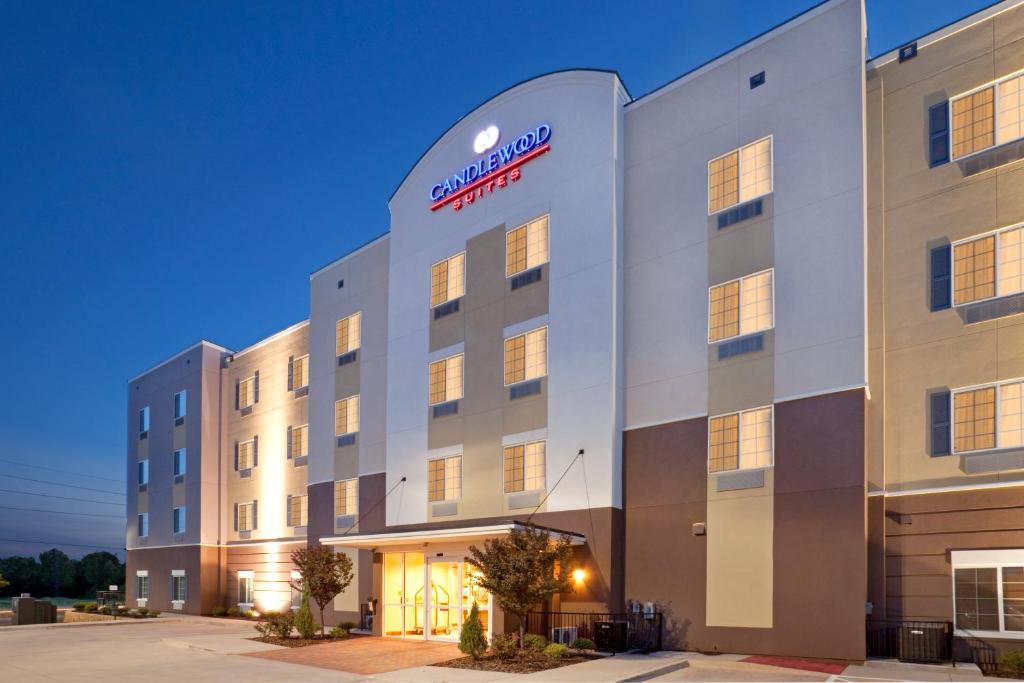 an exterior view of a hotel at night at Candlewood Suites Texarkana, an IHG Hotel in Texarkana - Texas