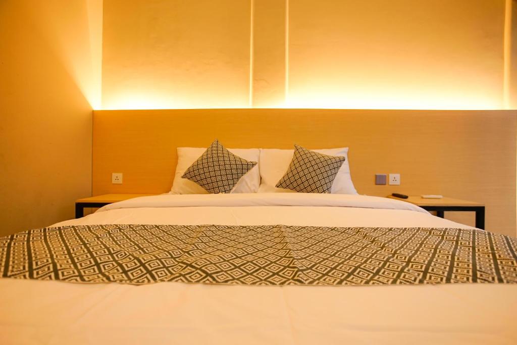 Postel nebo postele na pokoji v ubytování The Kubu Hotel