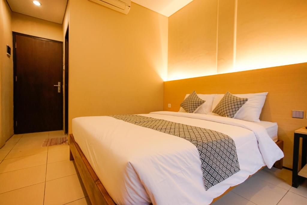 Postel nebo postele na pokoji v ubytování The Kubu Hotel