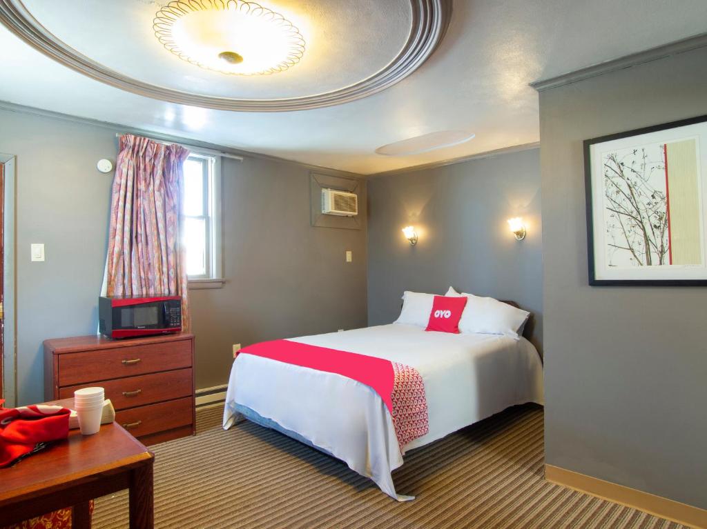 sypialnia z dużym łóżkiem i telewizorem w obiekcie OYO Hotel Wilkes-Barre East w mieście Wilkes-Barre