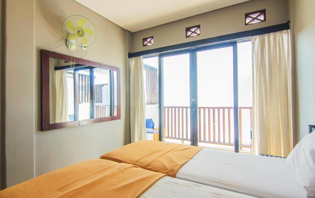 Postel nebo postele na pokoji v ubytování The Kubu Hotel