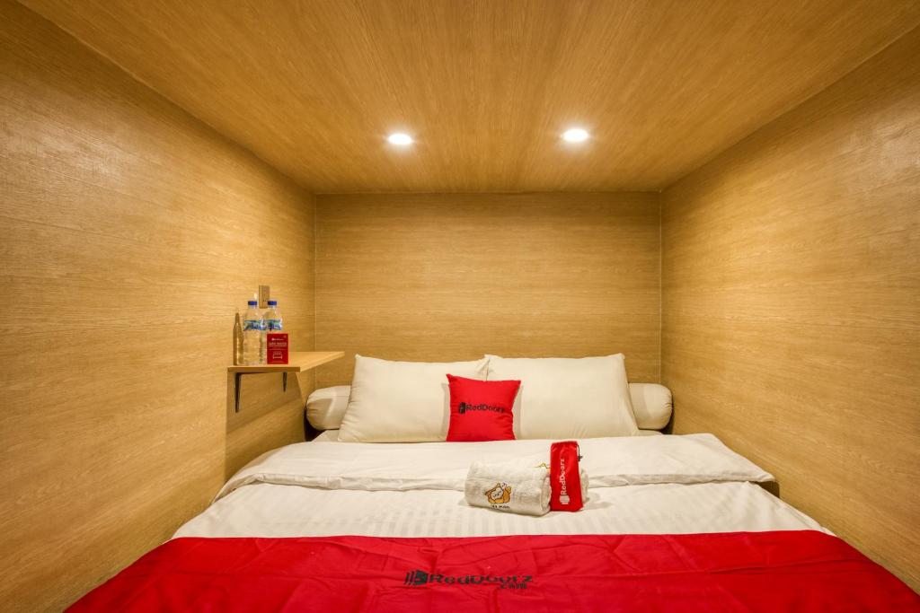 瑪琅的住宿－Reddoorz Hostel near Malang Train Station 3，一间小卧室,配有一张带红色毯子的床