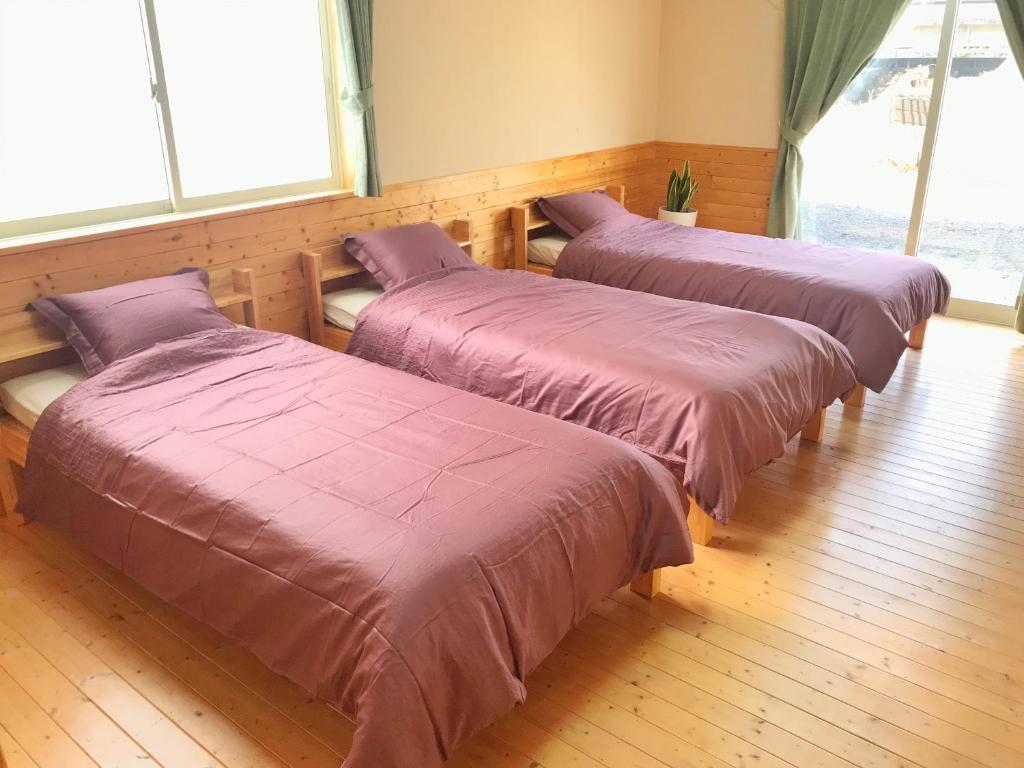 Postel nebo postele na pokoji v ubytování HIBARI GUESTHOUSE