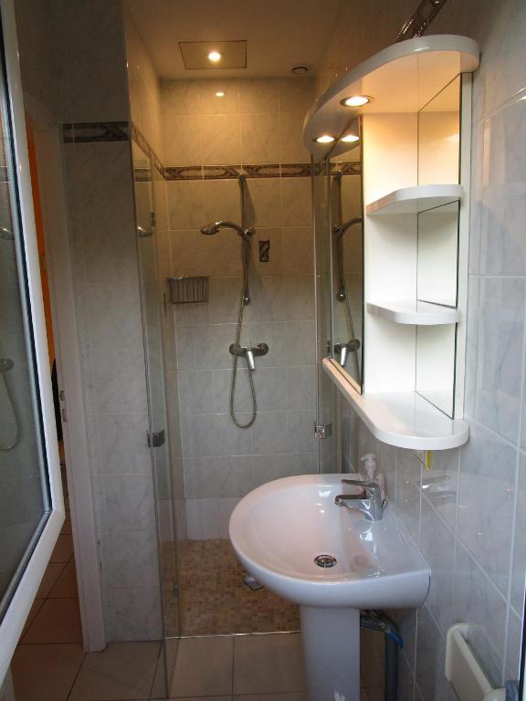 a bathroom with a sink and a shower at Locatlantique in Aytré