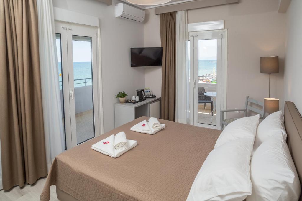 Postel nebo postele na pokoji v ubytování Hotel Alkyon