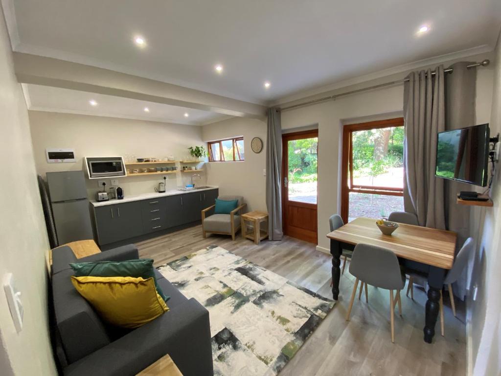 een woonkamer met een bank en een eetkamer bij Viettz Suite Annex in Stellenbosch
