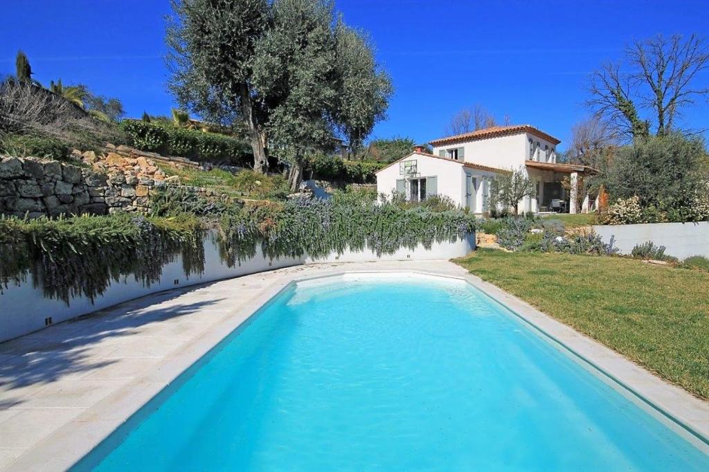 a swimming pool in front of a house at Côte d'Azur, Villa New Gold Dream with heated and privat pool, sea view in Le Rouret