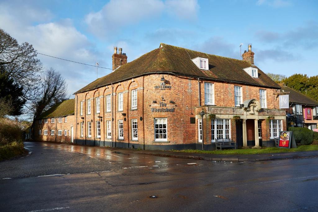 a large brick building on a street in front at Wheatsheaf by Chef & Brewer Collection in North Waltham
