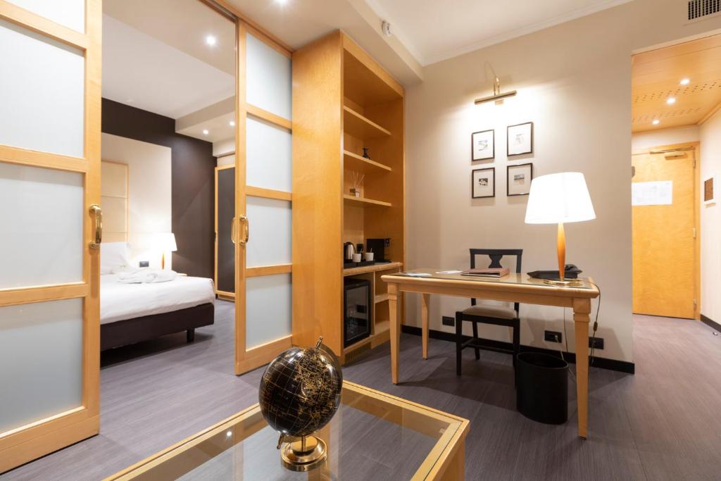 Postel nebo postele na pokoji v ubytování City Life Hotel Poliziano, by R Collection Hotels