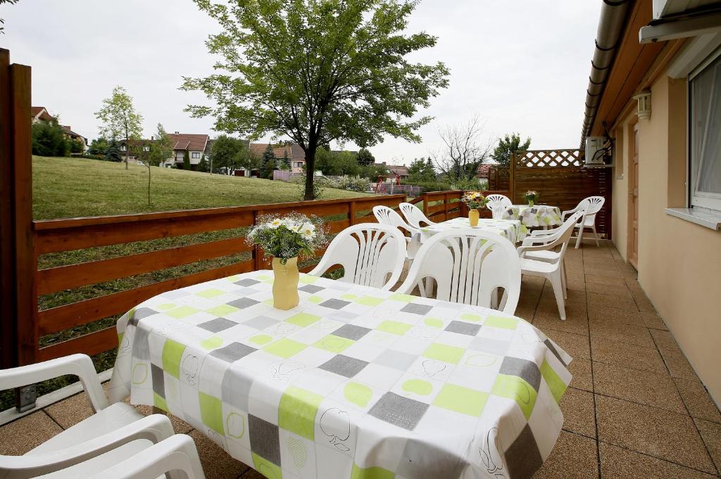 a table and chairs sitting on a patio with a table and chairs at Cecey Apartman in Eger