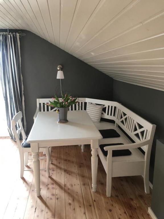 a white table and two chairs with a lamp on it at Bella Vista in Laufen