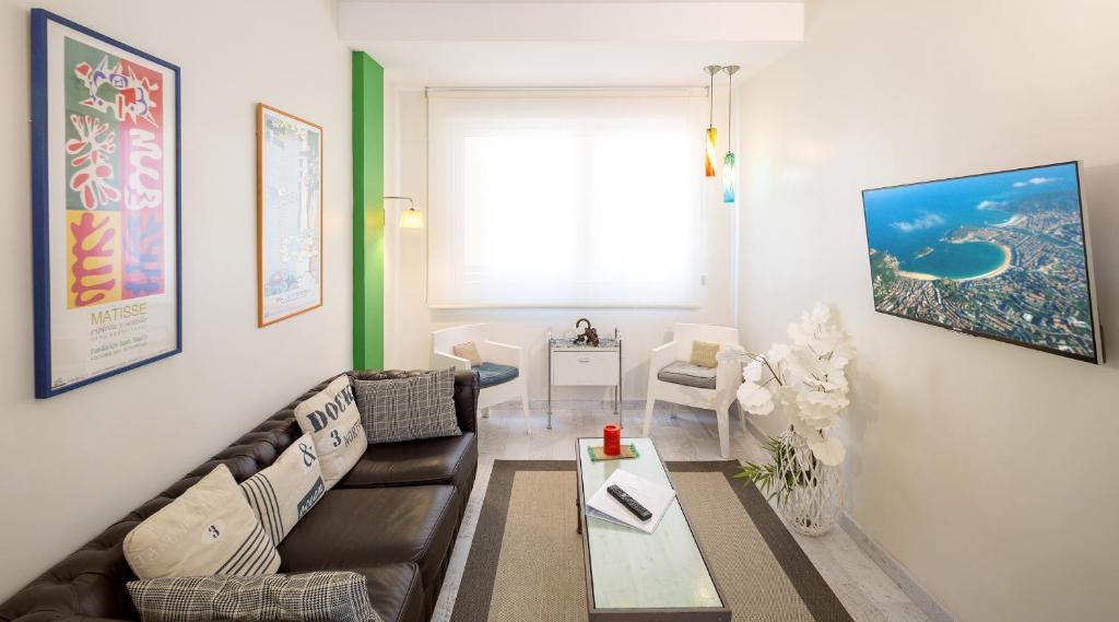 a living room with a couch and a table at BetiJai - Basque Stay in San Sebastián