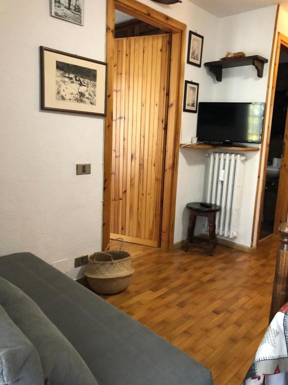 - une chambre avec un lit et du parquet dans l'établissement APPARTAMENTO MONTAGNA SAUZE D OULX, à Sauze dʼOulx