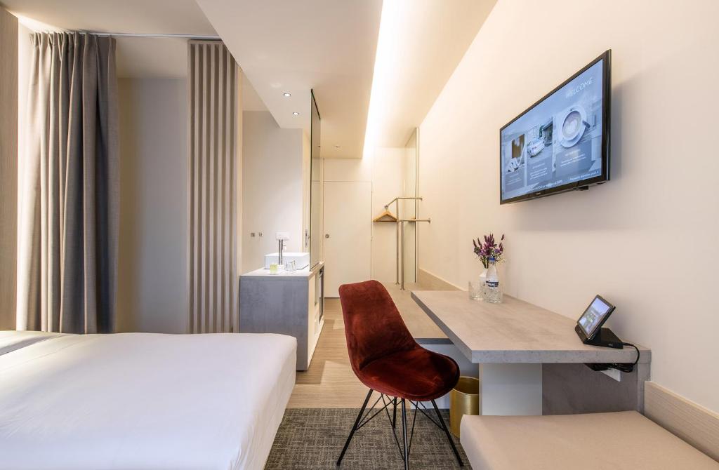 TV a/nebo společenská místnost v ubytování Begijnhof Hotel