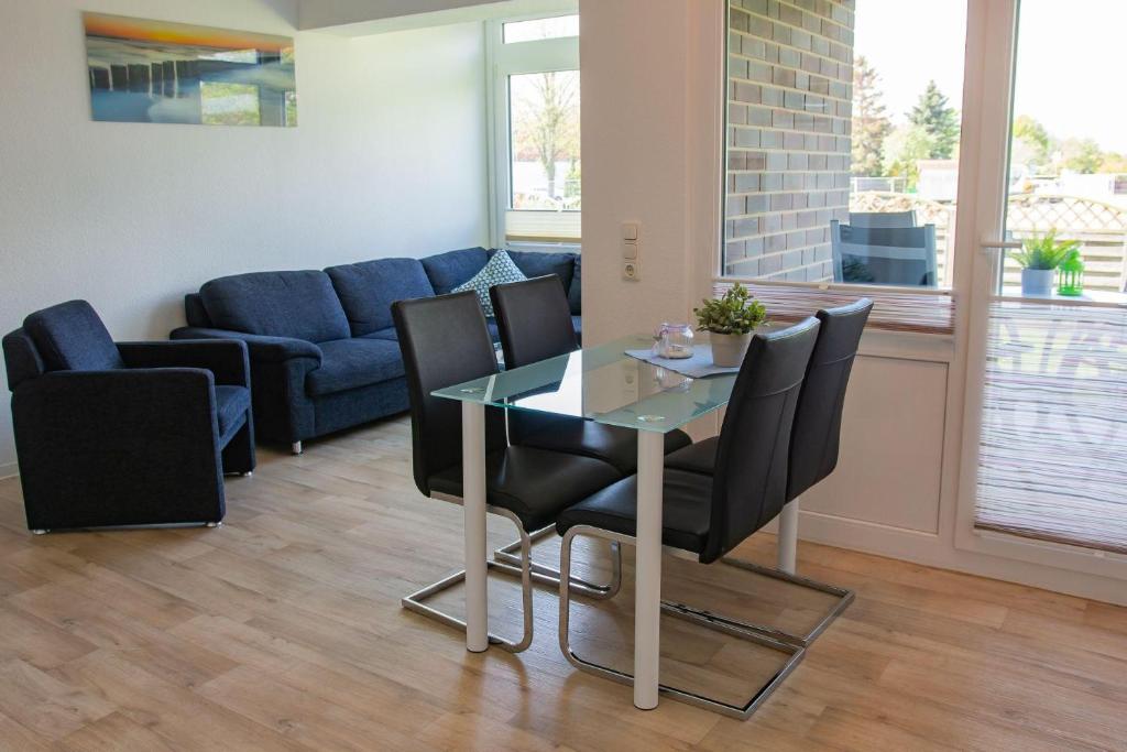 a living room with a glass table and chairs at Haus Strandburg Sonnenblick in Dahme