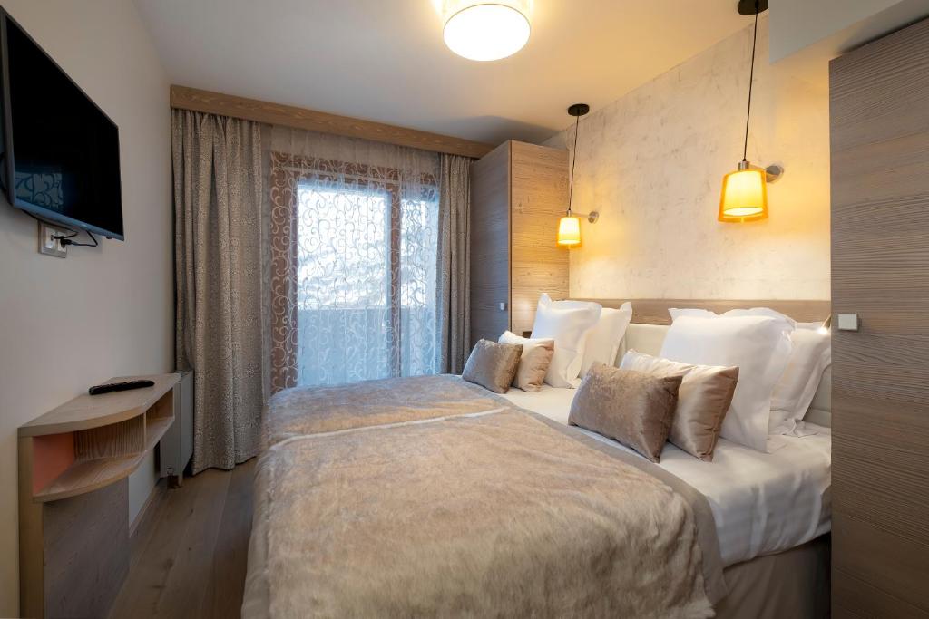 Кровать или кровати в номере Résidence Pierre & Vacances Premium L'Hévana