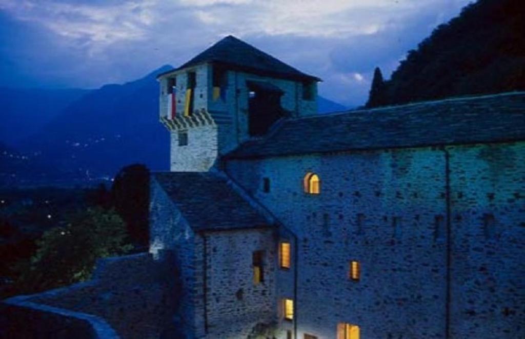 a building with a tower on top of it at night at Tre ponti Tipo C 5 in Verbania