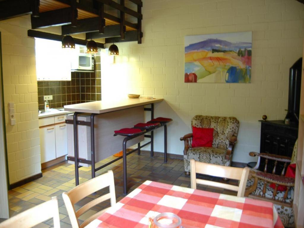 a kitchen with a table and chairs in a room at Holiday park- Biberbau in Schmallenberg