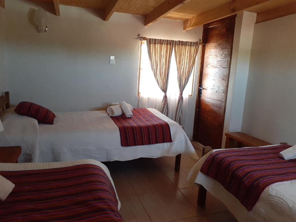 Postel nebo postele na pokoji v ubytování Hostal Nuevo Amanecer