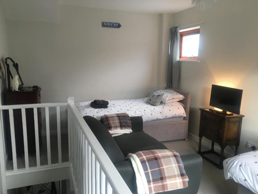 a small bedroom with a bed and a chair at Self-Contained Accommodation for 2 in Keswick