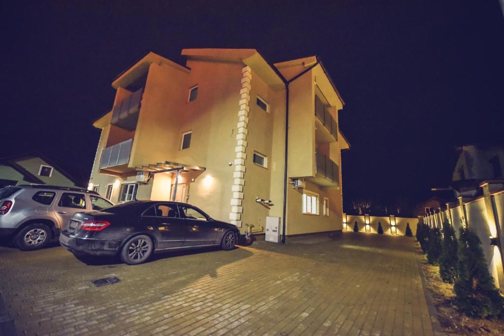 a car parked in front of a building at night at Vila Darimar Chișoda in Chişoda