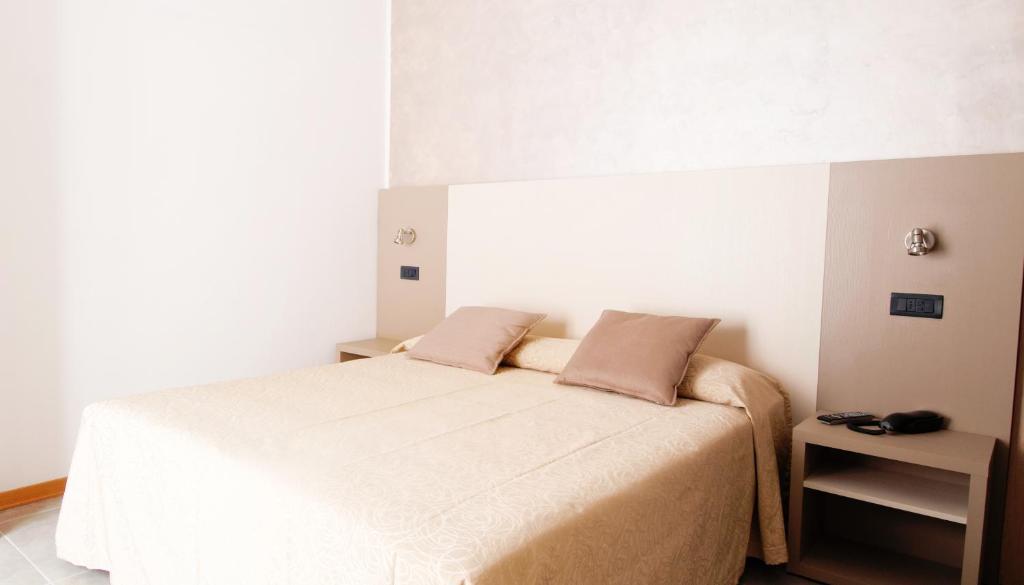 A bed or beds in a room at Hotel Aria di Mare - Bed & Brunch in centro a Riccione