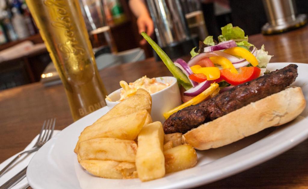 a plate of food with a hot dog and a salad at Tuckers Inn in Invergordon