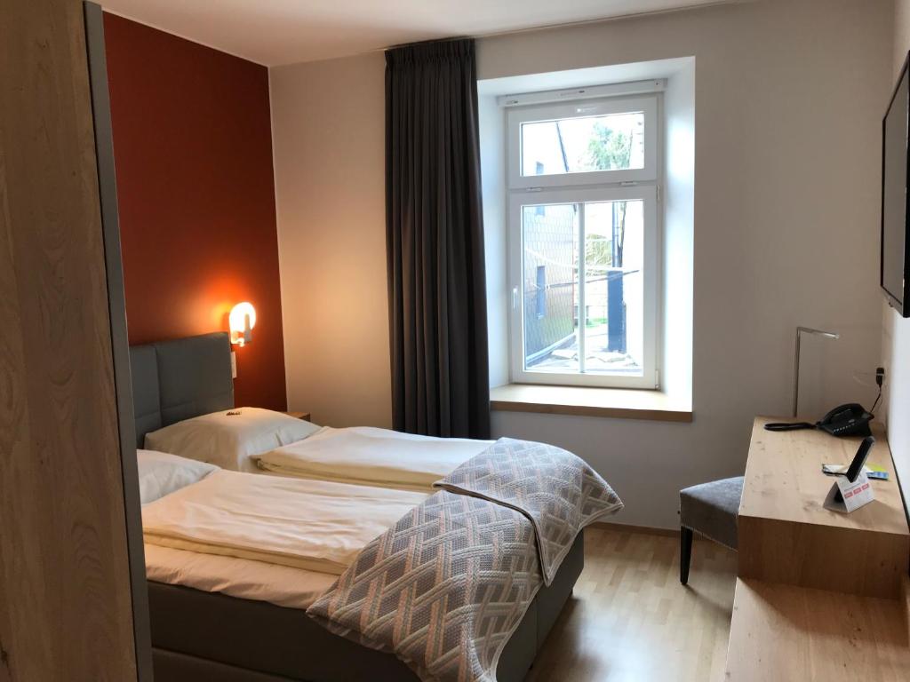 Postel nebo postele na pokoji v ubytování Hotel-Restaurant Zum Onkel Jonathan