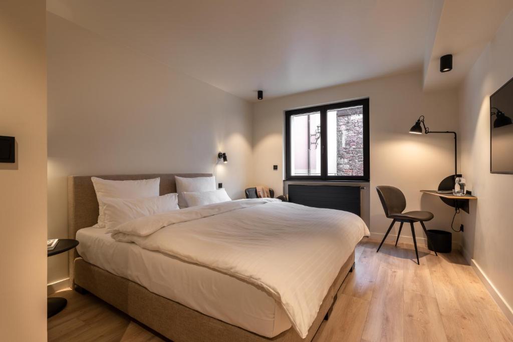 
Ein Bett oder Betten in einem Zimmer der Unterkunft THE ADAMS - Self Check In Hotel
