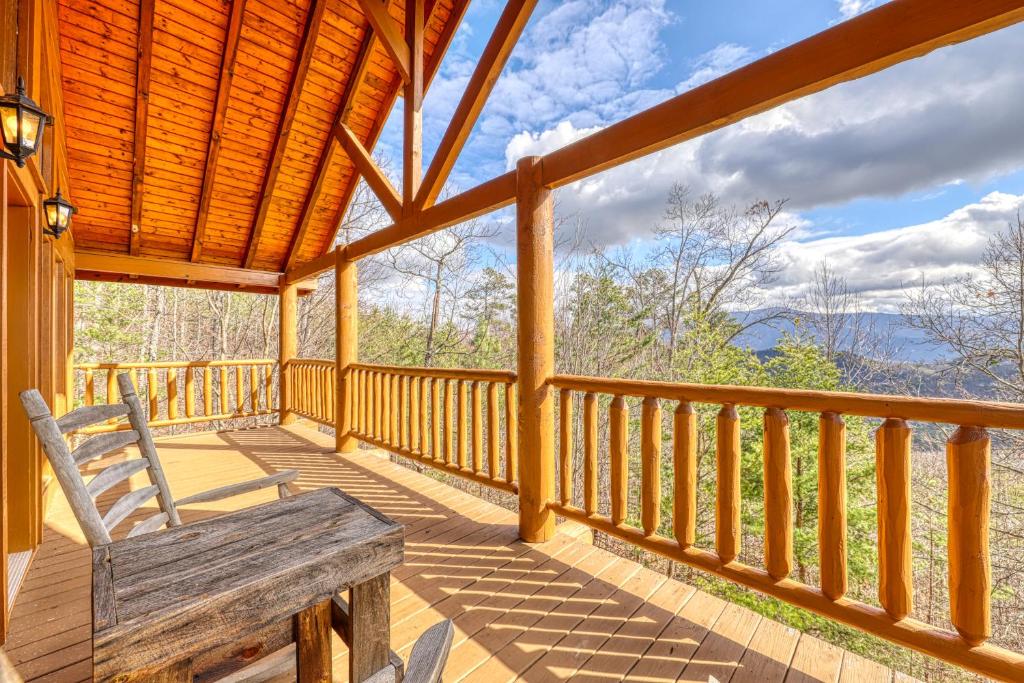 a wooden porch with a bench on a deck at Just the Two of Us in Pigeon Forge