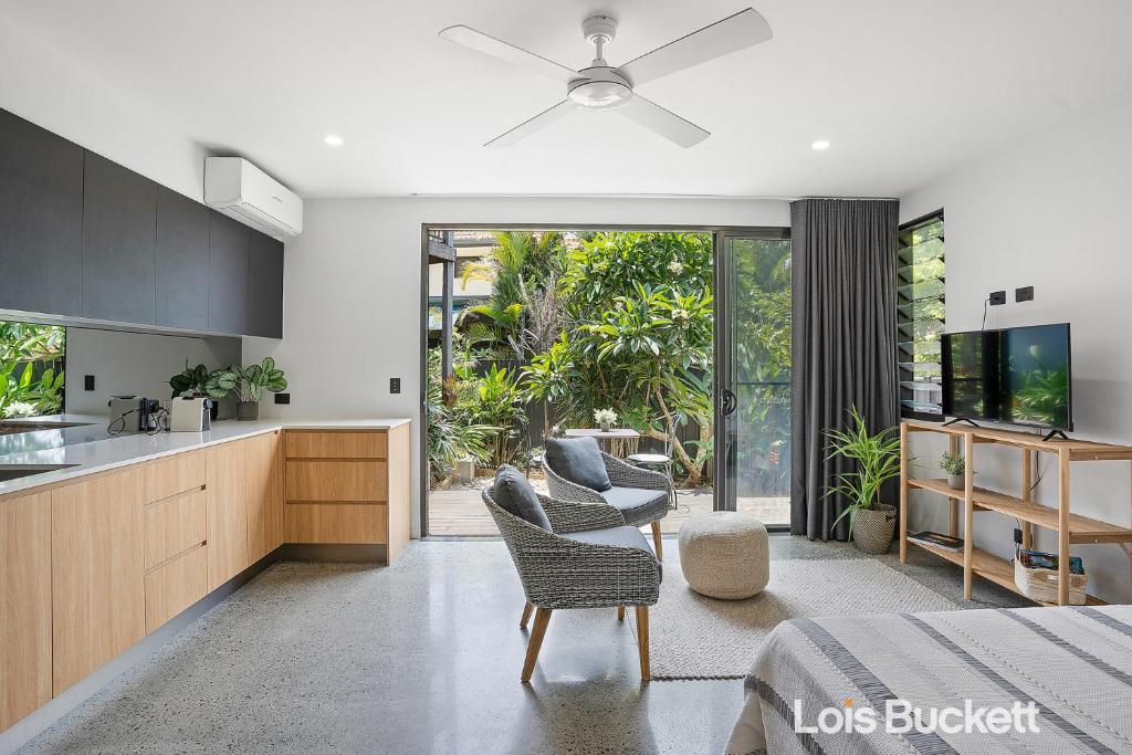 a kitchen and living room with a bed and a table at Crows Nest in Lennox Head