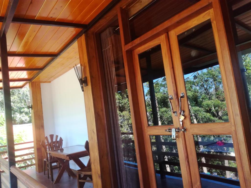 an open door to a screened in porch with a table at Cozy Homestay in Ella