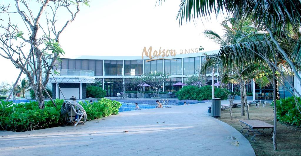 a resort with a swimming pool and a building at Oceanami Beach Club and Resort Long Hải in Long Hai